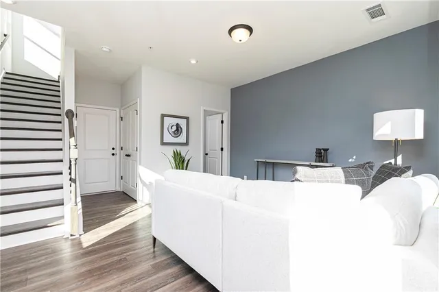 a living room with furniture and wooden floor