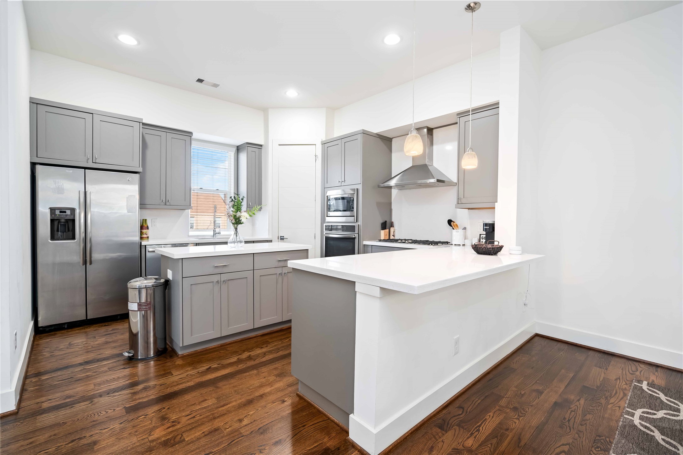 a kitchen with white cabinets and stainless steel appliances