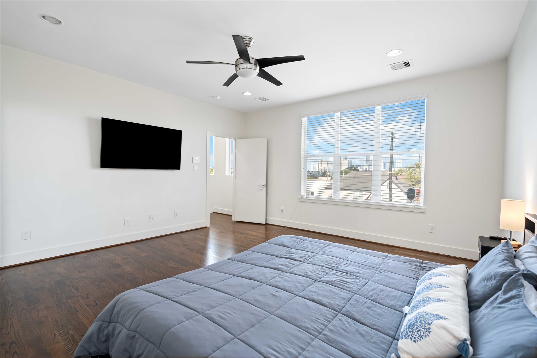 2004 Rosedale Street, Unit F Houston, TX 77004 - Photo 21 of 33 a bedroom with a large bed and a flat screen tv