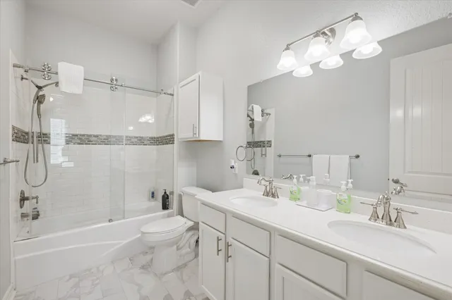 a bathroom with a double vanity sink mirror double and shower