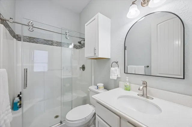 a bathroom with a sink toilet and shower