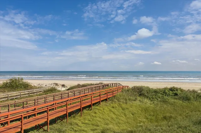 a view of swimming pool with outdoor seating and yard in back