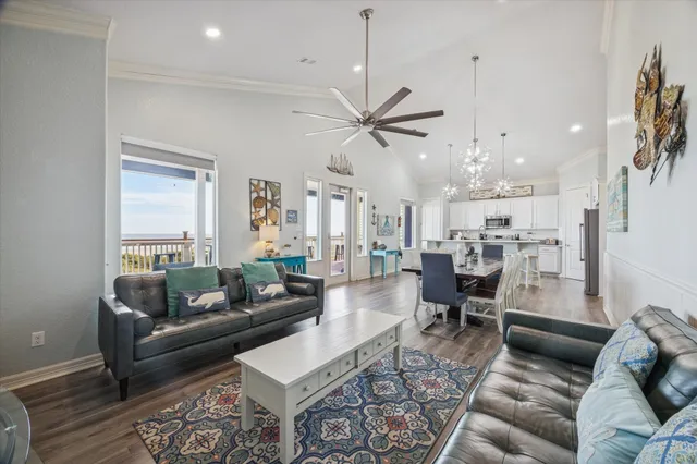 a living room with lots of furniture and a chandelier