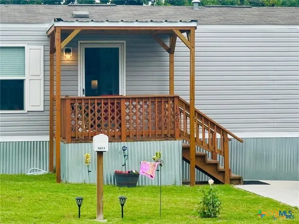 a backyard of a house with lots of green space and plants
