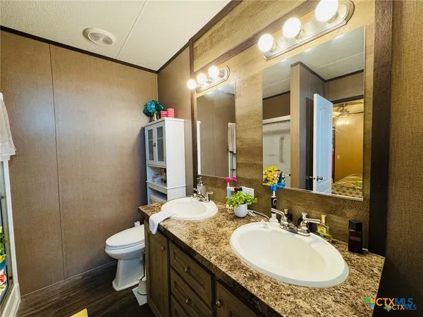 a bathroom with a sink mirror and vanity