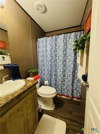 a bedroom with bed and a chandelier