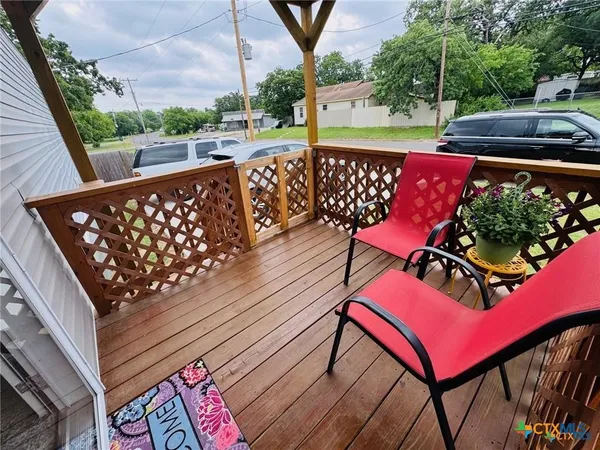 a view of a house with a yard and sitting area