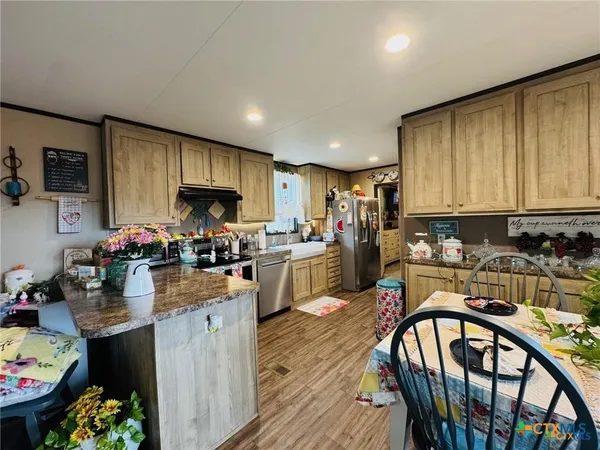 a kitchen with refrigerator and stove