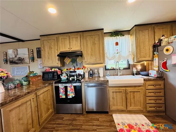 a kitchen with a sink cabinets and a window
