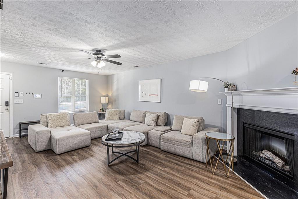 6536 Arbor Gate Drive Southwest, Unit 2 Mableton, GA 30126 - Photo 5 of 27 a living room with furniture and a fireplace