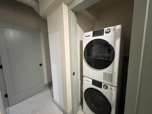 a view of a hallway with washer and dryer