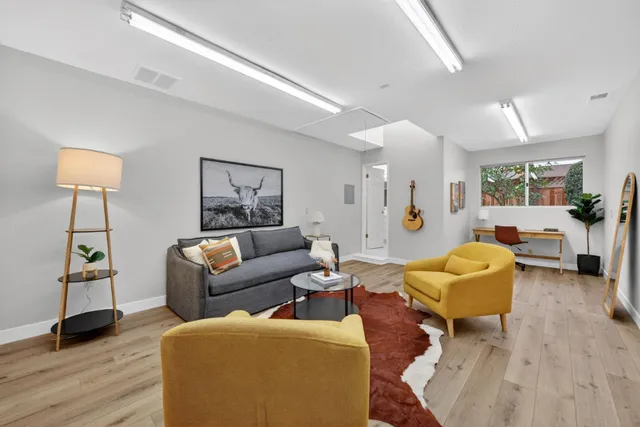 a living room with furniture and a lamp