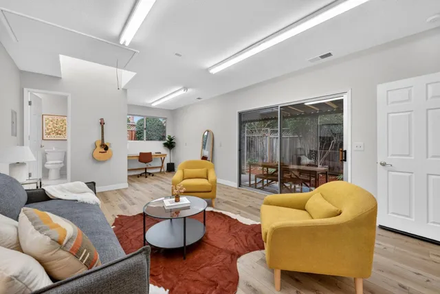 a living room with furniture and wooden floor