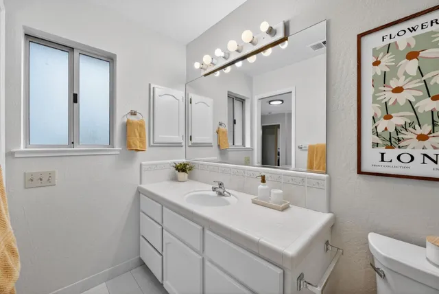 a bathroom with a sink vanity and a mirror