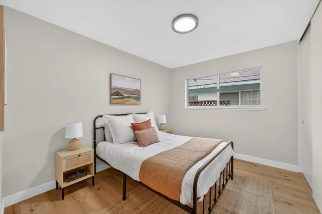 a bedroom with a bed and a night stand