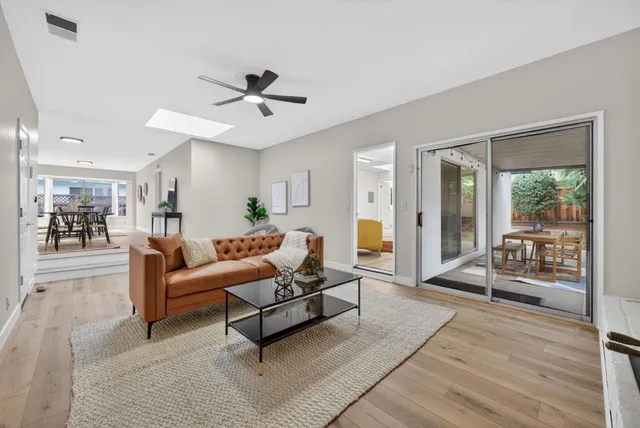 a living room with furniture and a large window with outer view
