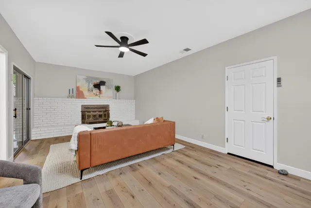 a living room with furniture and a fireplace