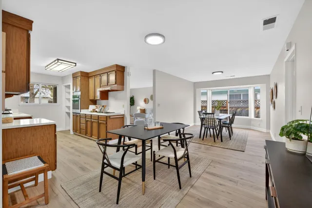 a view of a dining room with furniture and a potted plant