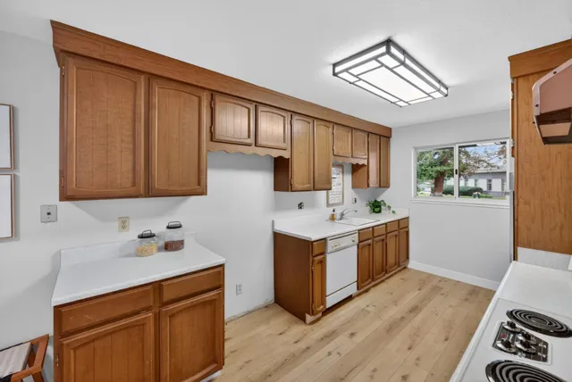 a kitchen with stainless steel appliances granite countertop a sink stove and cabinets