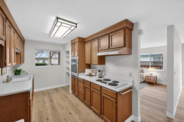 a kitchen with a stove and a white cabinets