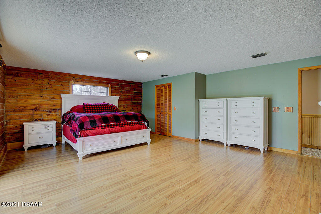 114 Pine Creek Court Ormond Beach, FL 32174 - Photo 19 of 41 a spacious bedroom with a bed and a dresser