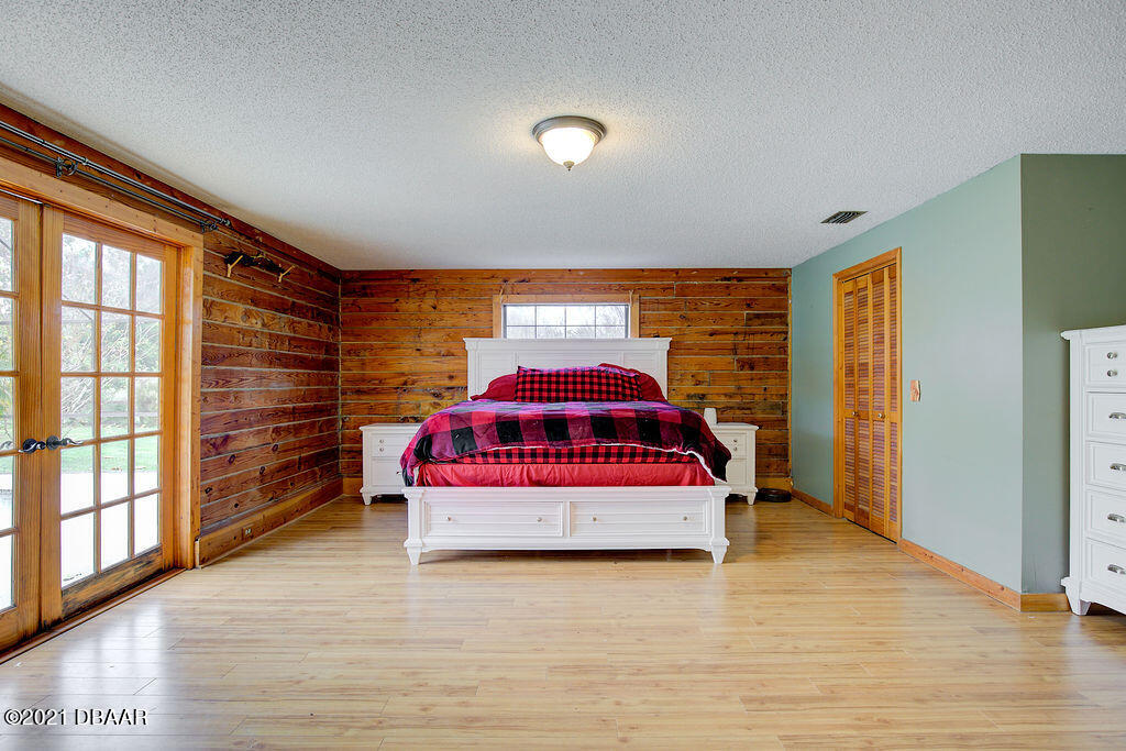 114 Pine Creek Court Ormond Beach, FL 32174 - Photo 22 of 41 a bedroom with a bed and a large window