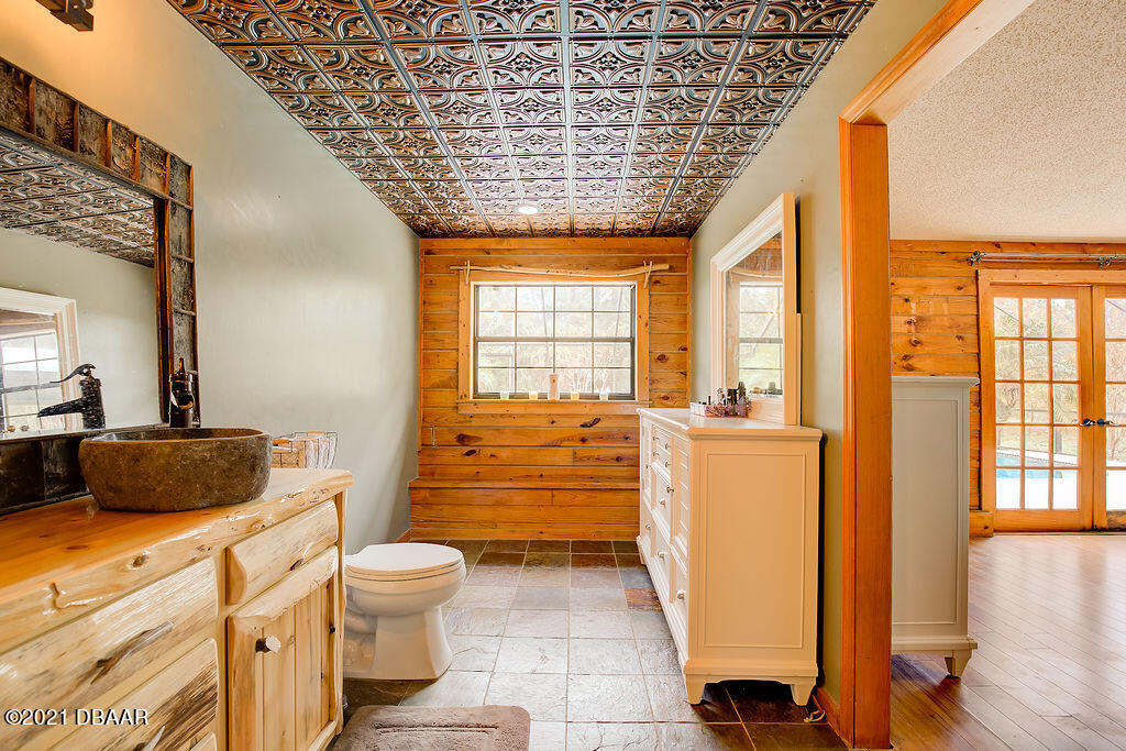 114 Pine Creek Court Ormond Beach, FL 32174 - Photo 24 of 41 a bathroom with a granite countertop sink toilet and shower