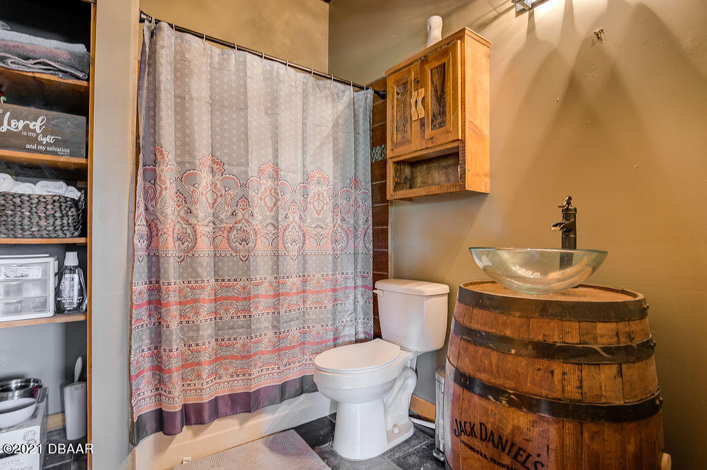 114 Pine Creek Court Ormond Beach, FL 32174 - Photo 29 of 41 a bathroom with a toilet and a shower curtain