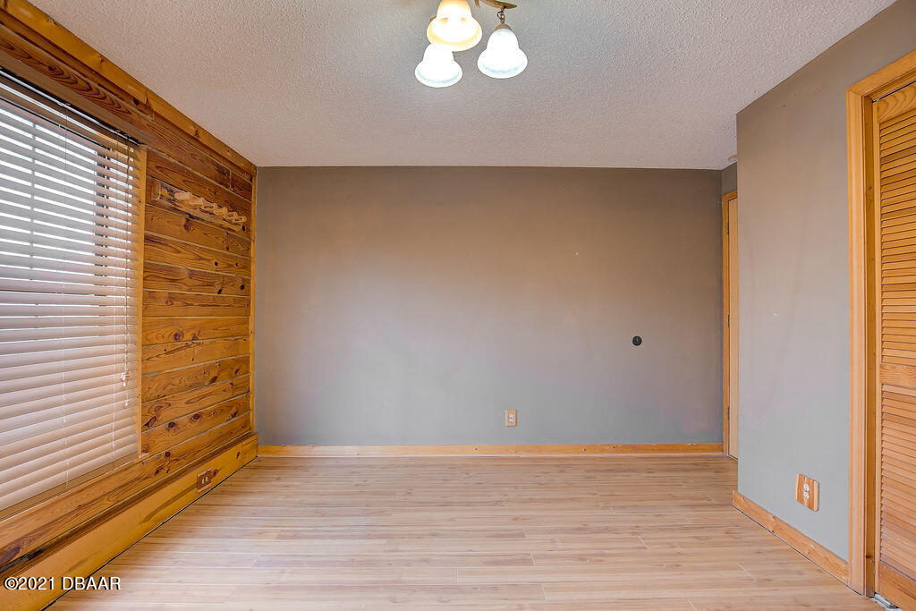 114 Pine Creek Court Ormond Beach, FL 32174 - Photo 30 of 41 a view of empty room with wooden floor and fan