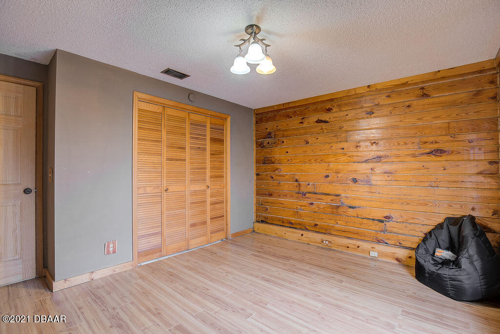114 Pine Creek Court Ormond Beach, FL 32174 - Photo 32 of 41 a view of empty room with wooden floor and fan