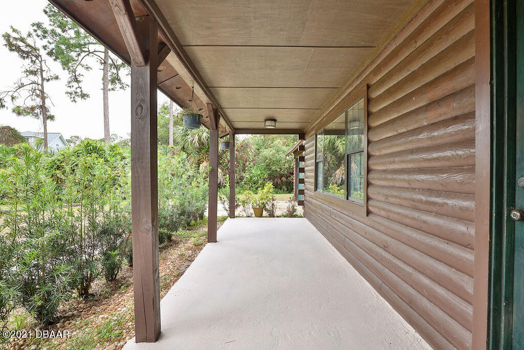 114 Pine Creek Court Ormond Beach, FL 32174 - Photo 4 of 41 a view of a patio with table and chairs and floor to ceiling window