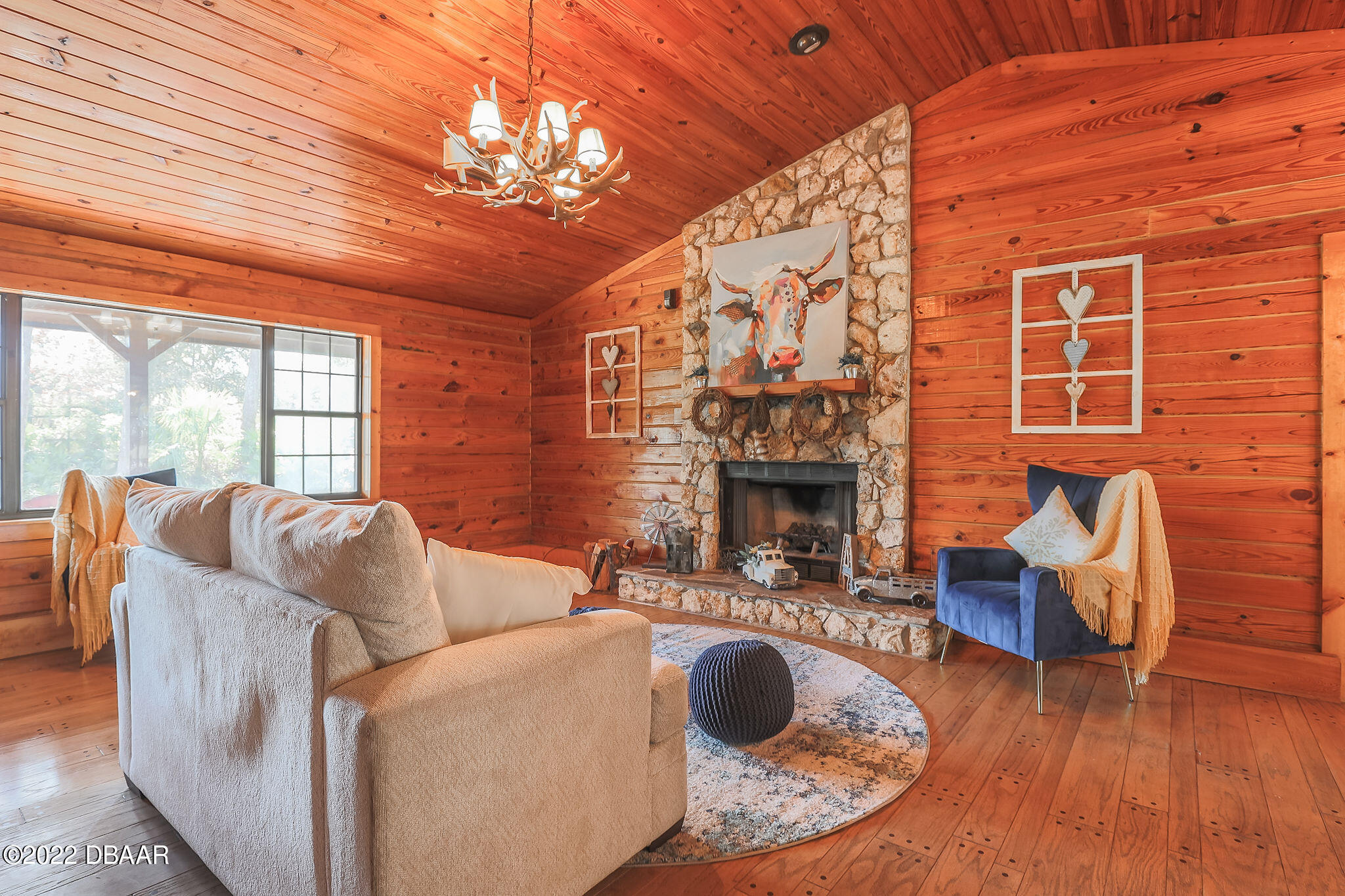 114 Pine Creek Court Ormond Beach, FL 32174 - Photo 7 of 41 a living room with furniture a fireplace and a chandelier