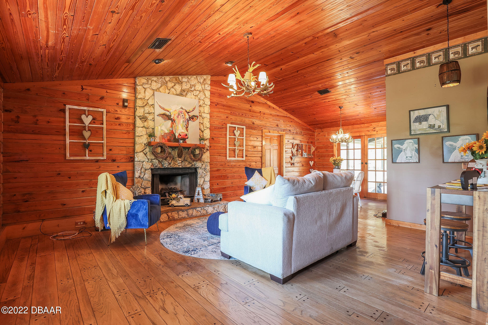114 Pine Creek Court Ormond Beach, FL 32174 - Photo 10 of 41 a living room with furniture a fireplace and a wooden floor