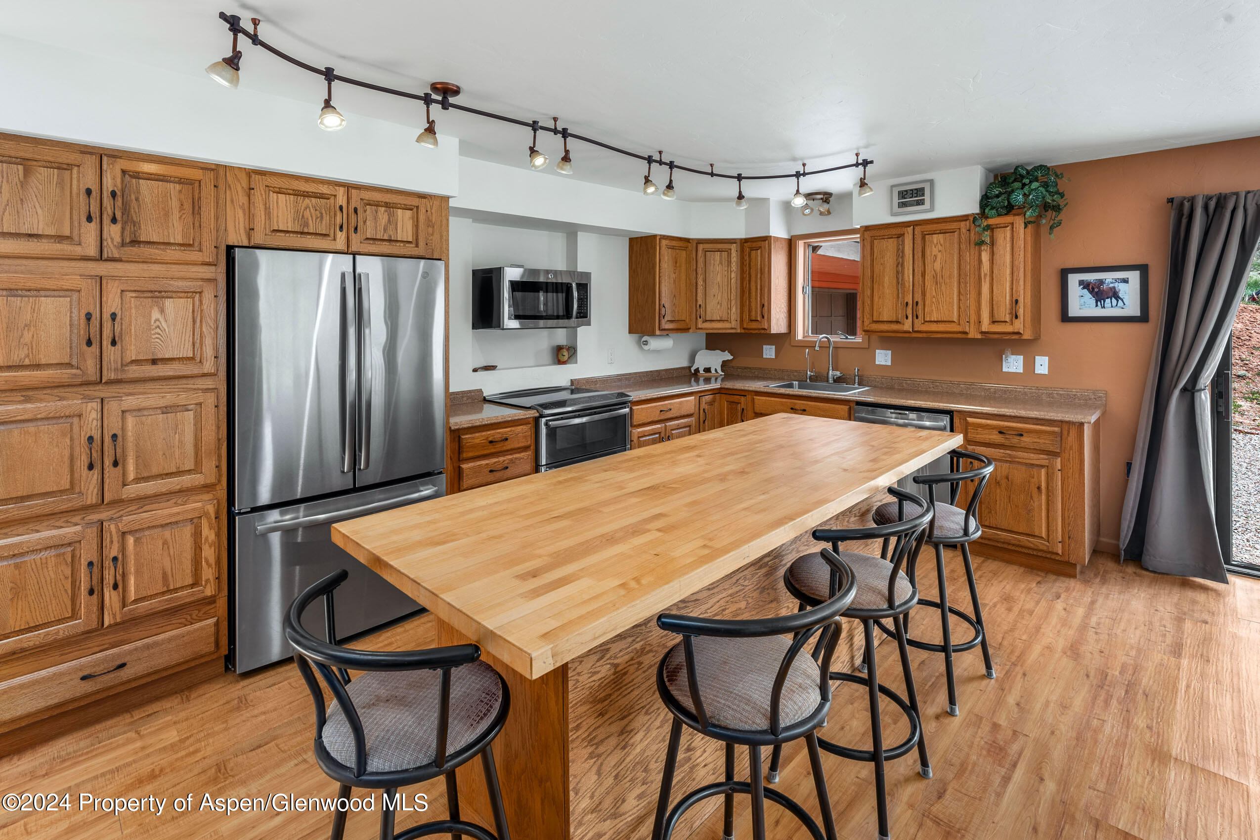 299 Knight Road Basalt, CO 81621 - Photo 11 of 48 a kitchen with stainless steel appliances granite countertop table chairs refrigerator and microwave