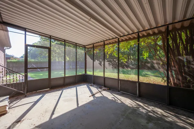 a view of an empty room with windows