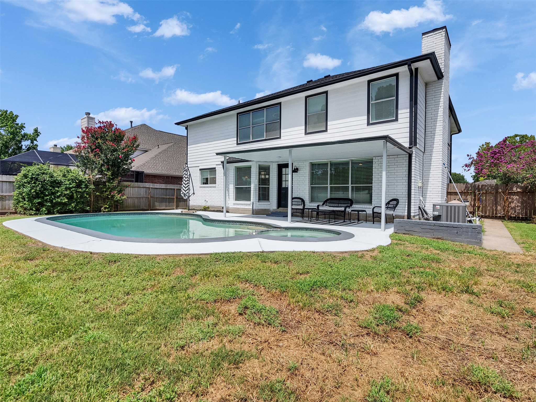 a view of a house with swimming pool and a yard