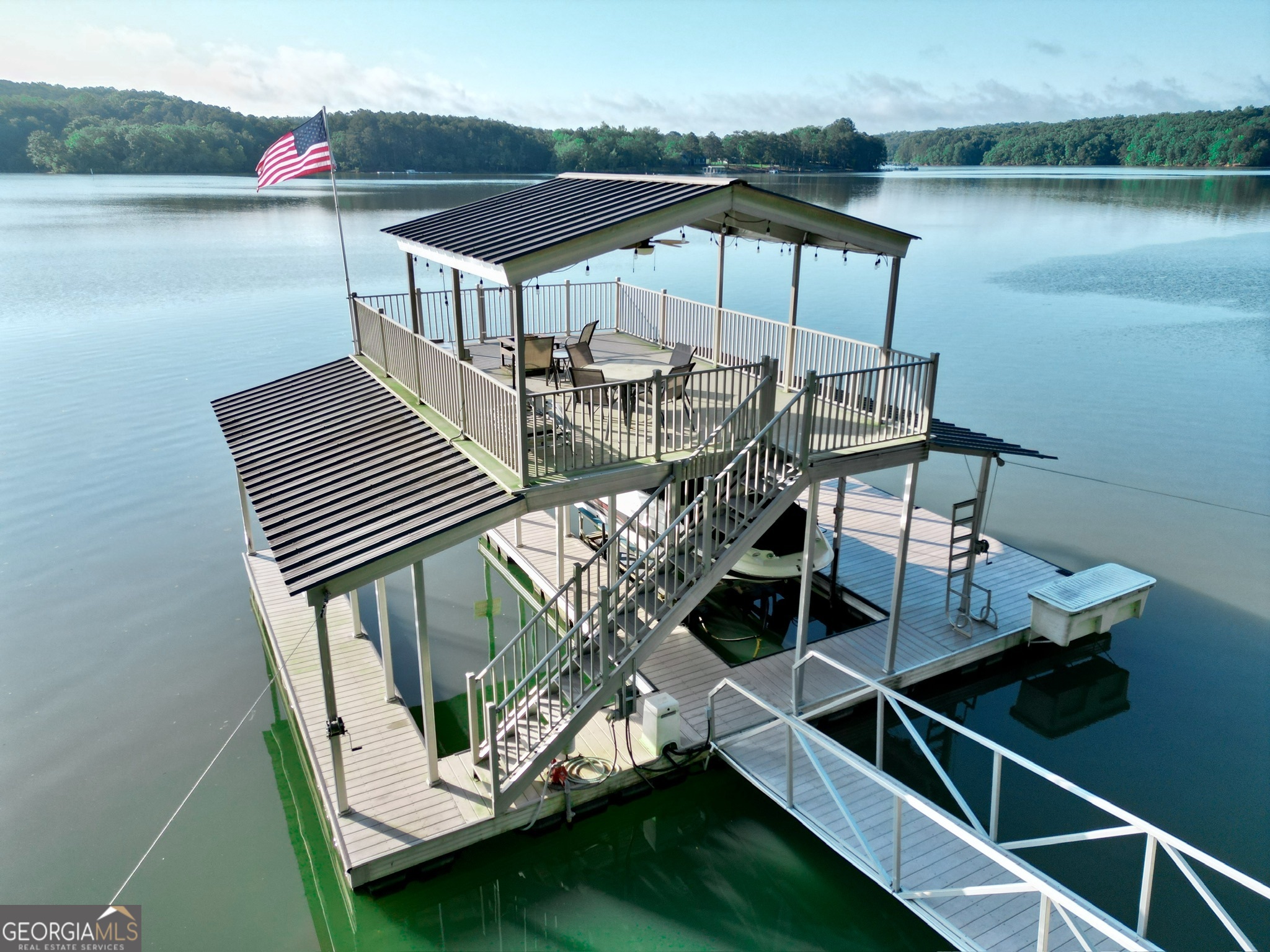 a terrace with outdoor seating and lake view