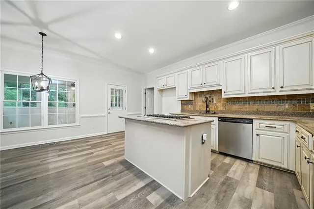 a view of an empty room with a fireplace and a window