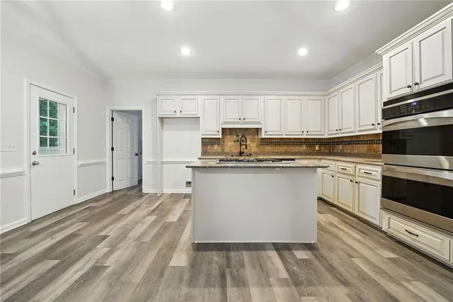 a spacious bathroom with a tub sink and mirror