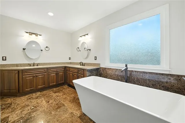 a bathroom with a double vanity sink a mirror and a shower