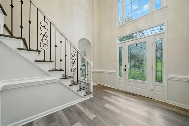 a view of entryway and hall with wooden floor