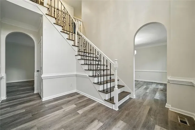 an empty room with windows and ceiling fan