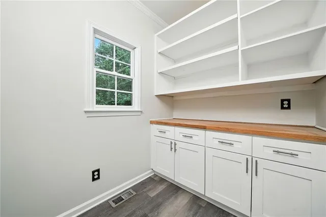 a view of a kitchen with stove and cabinets