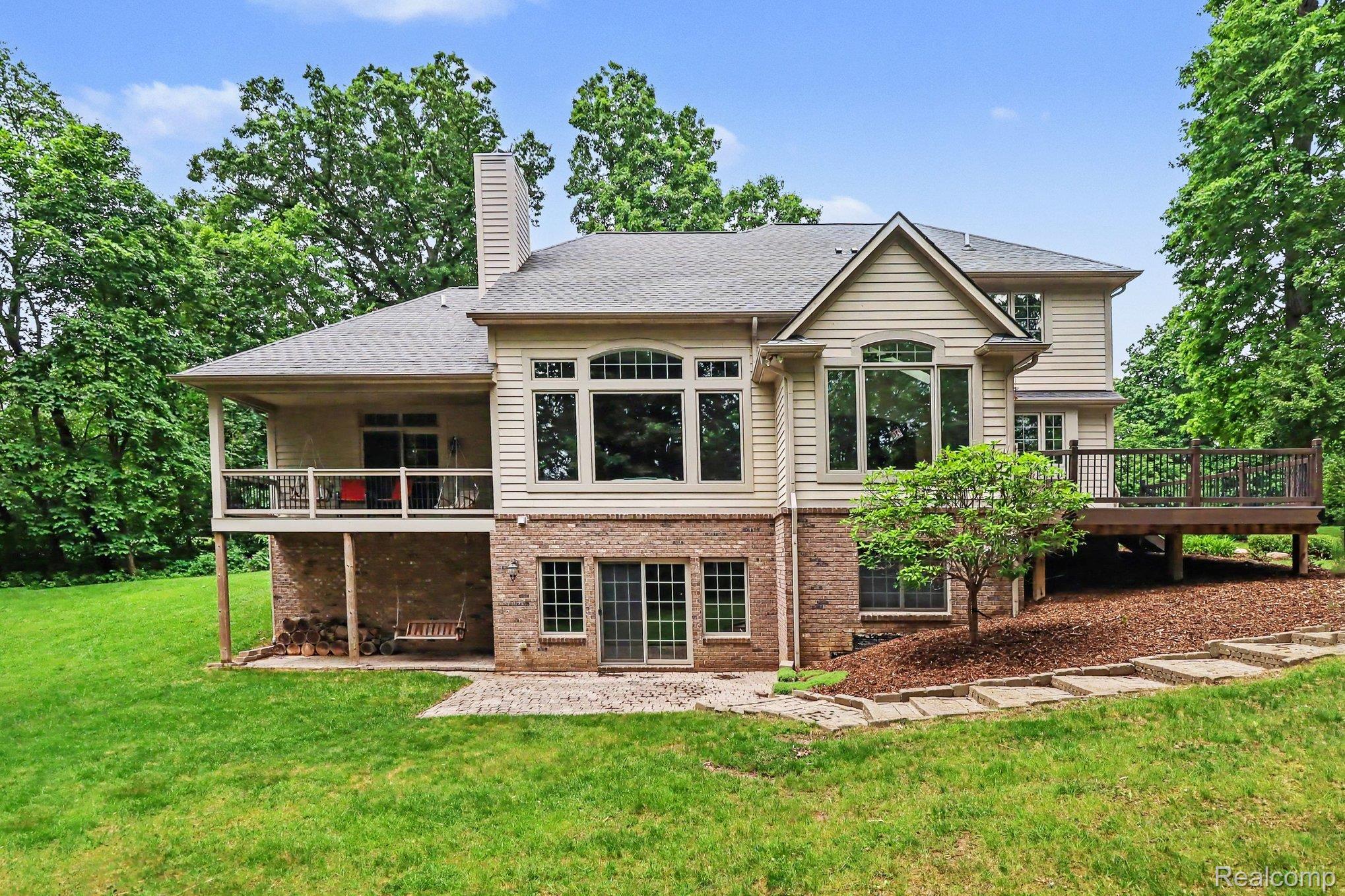 10490 Deer Ridge Trail Holly, MI 48442 - Photo 3 of 56 Expansive rear exterior featuring a multi-level design with brick and siding finishes