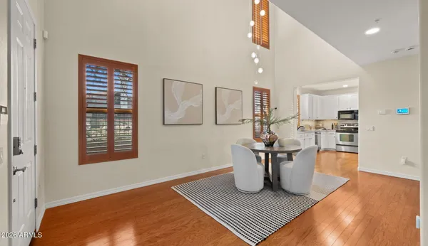 a living room with furniture a fireplace and a chandelier