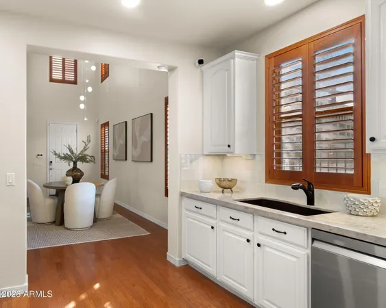 a living room with dining room and wooden floor