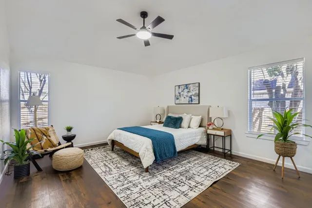 a bed room with bed and a potted plant