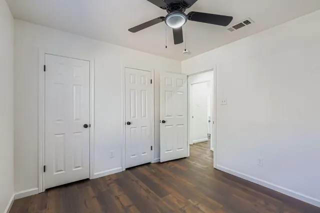 a view of an empty room and wooden floor
