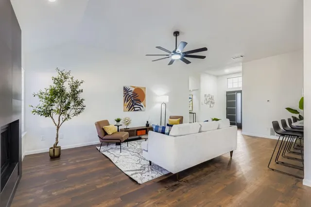 a living room with furniture and a potted plant