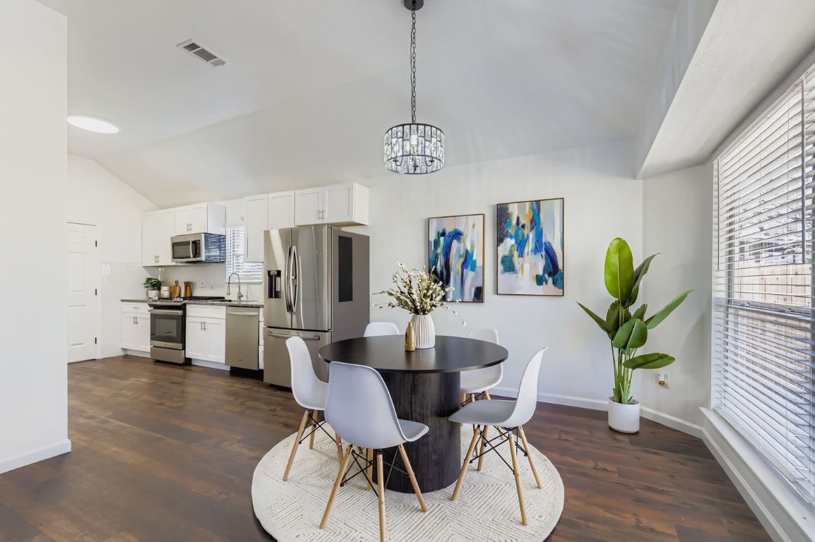 108 Susana Drive Georgetown, TX 78628 - Photo 9 of 26 a dining room with furniture potted plants and wooden floor